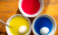 Dying Easter eggs red, yellow and blue